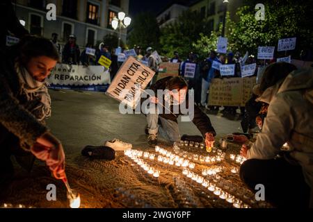 Madrid, Spain. 06th Feb, 2024. A protester lights candles during a rally. The Madrid neighborhood of Lavapies have commemorated the one year of tragedy of El Tarajal where in the early hours of February 6, 2014, more than 250 people of sub-Saharan origin tried to enter Ceuta through El Tarajal beach and were repelled by the Civil Guard, and 15 people died and other 23 were returned to Morocco. Credit: SOPA Images Limited/Alamy Live News Stock Photo