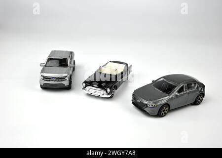 Three Hot Wheels toy cars on white background – Wales, UK  –  6 February 2024 Stock Photo