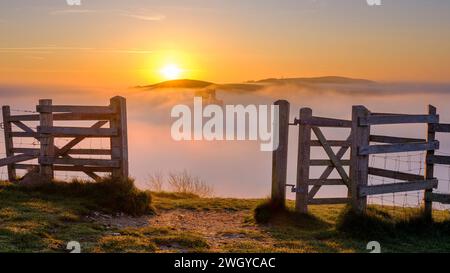 Corfe, UK - April 8, 2023: Misty spring sunrise on Corfe Castle, Isle of Purbeck in Dorset, UK Stock Photo