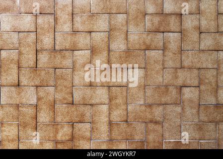 A wall covered in small rectangular brown tiles. Vector tile texture background Stock Photo