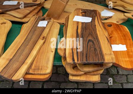 Handmade art and craft olive tree wooden chopping boards on market outdoors Stock Photo