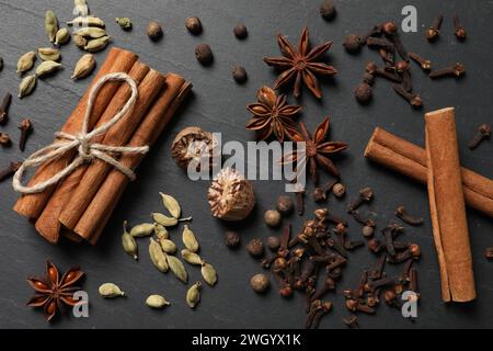 Different spices on dark gray textured table, flat lay Stock Photo