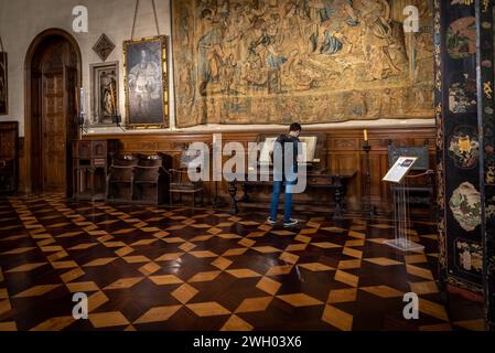 BUENOS AIRES, ARGENTINA, JANUARY 30, 2021: Young man looking at ancient antiphonary at empty Museum of Decorative Art Stock Photo
