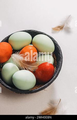 Naturally pastel colored Easter eggs in a basket close-up Stock Photo