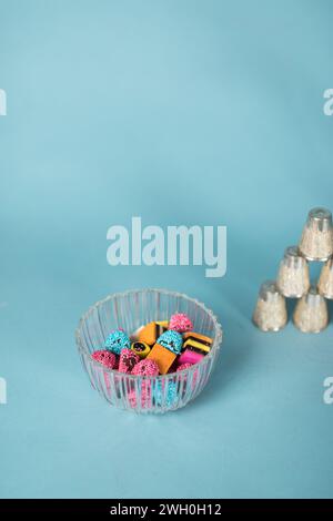 British licorice allsorts candy in glass bowl on light blue background Stock Photo