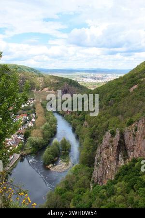 Bad Munster, Germany - May 12, 2021: Nahe River surrounded by hills and cliffs on a spring day in Rhineland Palatinate, Germany. Stock Photo