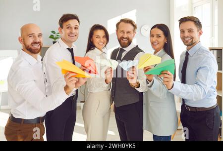 Happy business people holding paper planes planning travel or rejoicing in successful cooperation Stock Photo