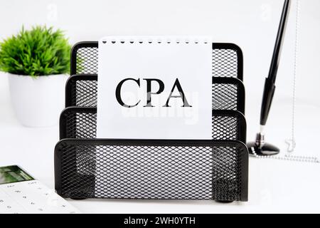 CPA, Certified Public Accountant or Cost per Action A word written on a piece of paper from a notebook on a stand on a white background Stock Photo