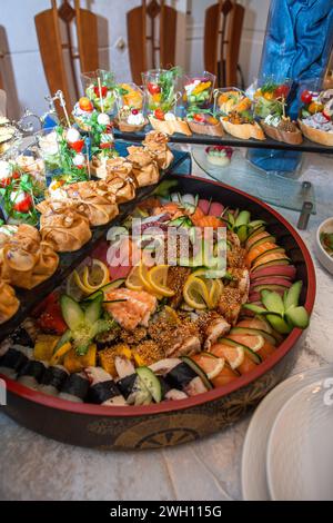 A selection of appetizers like sushi, bruschetta, and canapes arranged on a platter. Ideal for elegant gatherings or catering events. Isolated on a wh Stock Photo