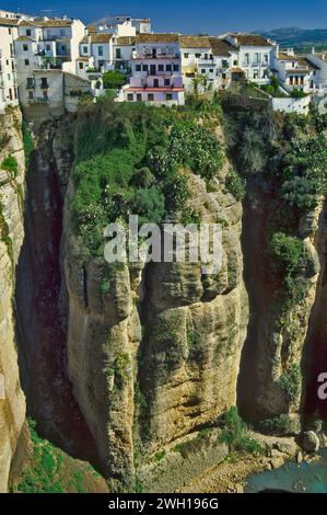 Houses in Ronda on cliff over Guadalevín River Gorge, view from Puente Nuevo, province of Malaga, Andalusia, Spain Stock Photo