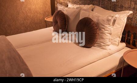 Two pillows placed neatly side by side on a cozy bed in a hotel room Stock Photo