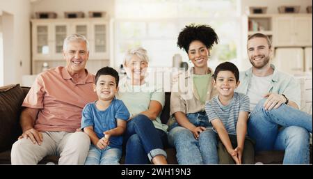 Happy, smile and face of a big family on a sofa relaxing, bonding and spending time together. Happiness, love and portrait of boy children sitting Stock Photo