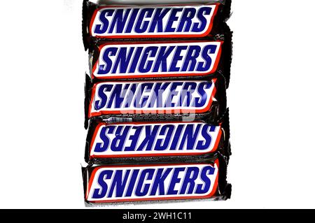 Cairo, Egypt, February 4 2024: Snickers, a brand of chocolate bar consisting of nougat topped with caramel and peanuts, all encased in milk chocolate, Stock Photo