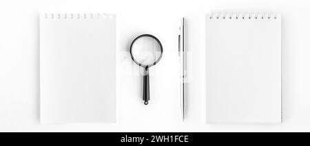 Spiral Notepad and Notepad Page with Pen and Magnifying Glass Stock Photo
