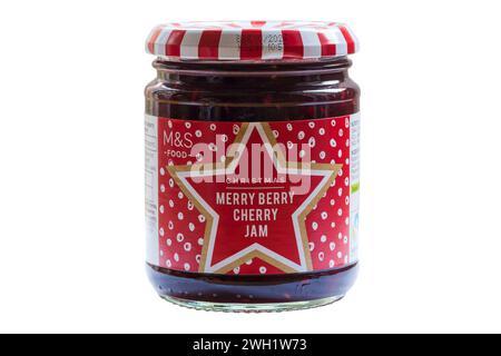 Jar of Christmas Merry Berry Cherry Jam from M&S isolated on white background - cranberry cherry and raspberry extra jam with cinnamon Stock Photo