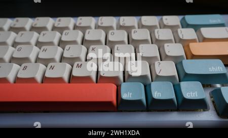 A closeup shot of a wireless mechanical keyboard with colorful keycaps Stock Photo