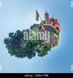 little planet with hindu maruti temple of ape goddess hanuman in jungle in Indian tropic village on tiny planet in blue sky, transformation of spheric Stock Photo
