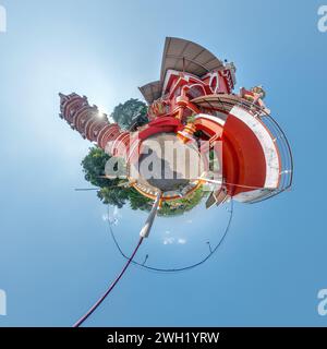 little planet with hindu maruti temple of ape goddess hanuman in jungle in Indian tropic village on tiny planet in blue sky, transformation of spheric Stock Photo