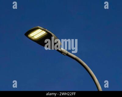 Artificial neon light, during day. Against blue sky background. Stock Photo