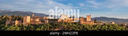 Panoramic sunset hour time of Alhambra medieval palace and fortress complex with Sierra Nevada snowy mountains in Granada, Andalusia, Spain. Known as Stock Photo