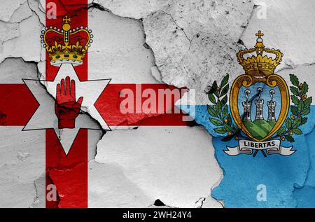 flags of Northern Ireland and San Marino painted on cracked wall Stock Photo