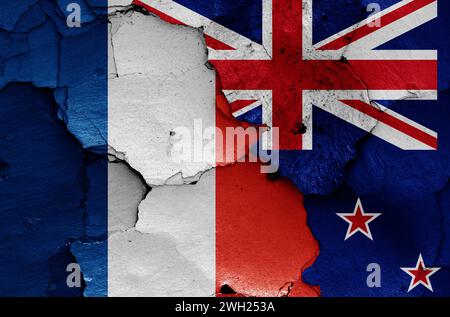 flags of France and New Zealand painted on cracked wall Stock Photo