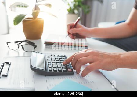 Budget and loan paper in office. Business accounting concept with businessman using calculator. Stock Photo