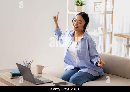 Asian woman listening to music, have break, working from home Stock Photo