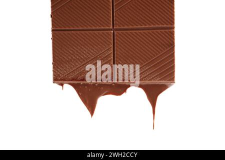 Piece of melted chocolate bar isolated on white background. Chocolate drips. Stock Photo