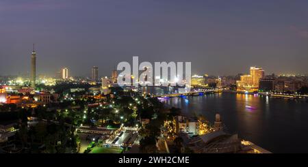Aerial view of the city of Cairo at night along the river Nile. Skyline ...