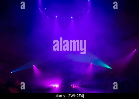 Bright festive multi-colored stage lighting with optical flare and rays from lighting lamps. Stock Photo