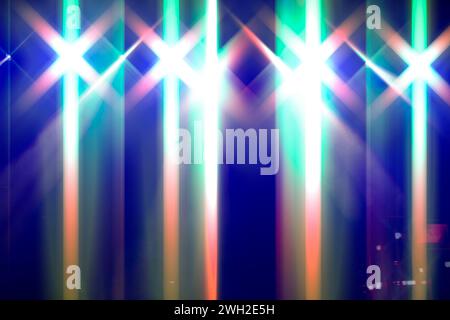 Bright festive multi-colored stage lighting with optical flare and rays from lighting lamps. Stock Photo