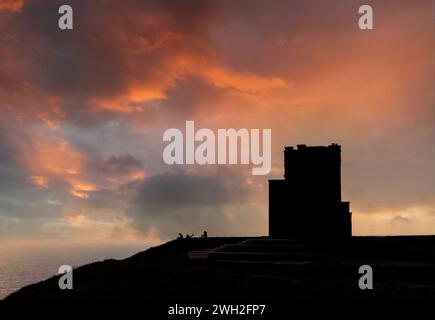 O'Brien's Tower, sunset behind the folly situated on the edge of the Cliffs of Moher in County Clare, Ireland. Stock Photo