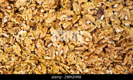 A close-up of brown and white textured walnuts with hints of light brown. Stock Photo