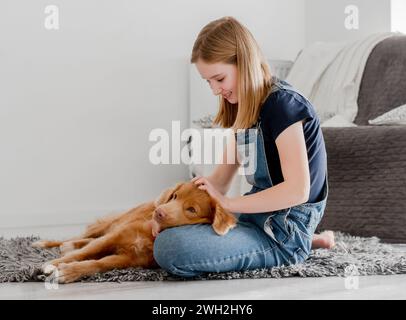 11-Year-Old Girl Plays With Nova Scotia Retriever Toller At Home On The ...