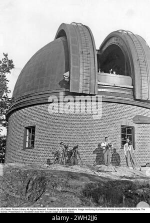 A solar eclipse occurs when the Moon passes between Earth and the Sun, thereby obscuring the view of the Sun from a small part of the Earth, totally or partially.  In a total eclipse, the disk of the Sun is fully obscured by the Moon. The picture is taken on july 9 1945 when people are observing the total ecliplse from and at the observatory in Saltsjöbaden Sweden. Stock Photo