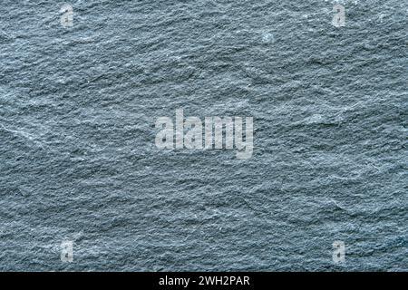 Texture of dark grey slate coaster plate as a background. Stock Photo