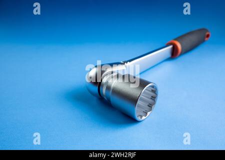 Ratchet wrench on blue background Stock Photo