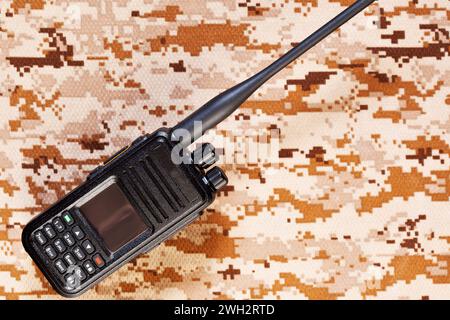 Black two-way radio with antenna on camouflage background Stock Photo
