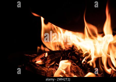 Cooking on a cauldron on a fire. Flames of fire in the dark. Stock Photo