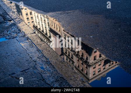 Reflections in a puddle in the Flatiron neighborhood in New York on Saturday,February 3, 2024.  (© Richard B. Levine) Stock Photo