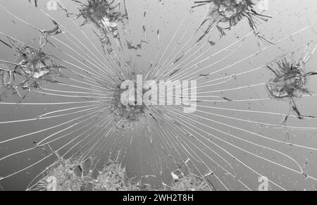 Texture of cracked glass on grey background. Stock Photo