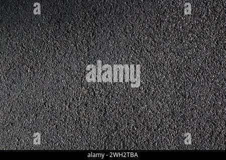 Texture of rubber cover for running tracks and playgrounds. Black rubberized asphalt background. Stock Photo