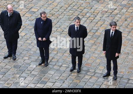 Members of the French government, from L to R: Justice Minister, Eric Dupond-Moretti; Armed Forces Minister, Sebastien Lecornu; Interior Minister Gerald Darmanin and Prime Minister Gabriel Attal wait for French President Emmanuel Macron to arrive before heading a ceremony in tribute to the French victims of the Hamas' Oct 7th attack in southern Israel at the Invalides in Paris, on Wednesday, February 7, 2024, four months to the day after armed gunmen from Gaza executed 1,200 people and kidnapped 253 hostages. Republican guards held the portrait-pictures of the 42 French victims of the massacre Stock Photo