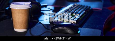 modern set-up with a sleek computer keyboard and mouse on a table next to a cup of coffee,banner Stock Photo