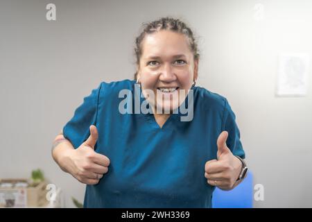 Funny positive woman displaying thumbs up sign as approval, agreement and motivation emotion. Stock Photo