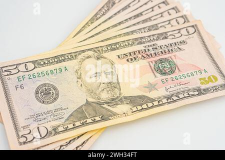 Fifty 50 dollar bills fanned out on a white background. Lots of 50 dollar bills, the concept of American cash. US paper money. Bribery with a wad of m Stock Photo