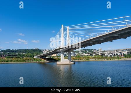 A wide-angle photo of the Tilikum Crossing Bridge as viewed from the Willamette River. Stock Photo