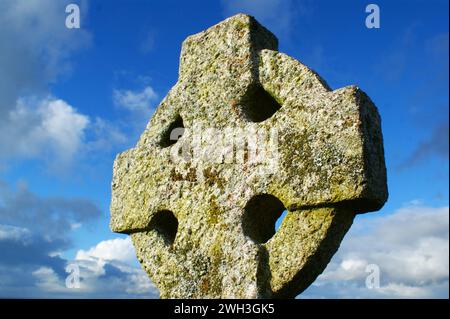 Stone cross. Old Celtic cross on sky background. Stock Photo