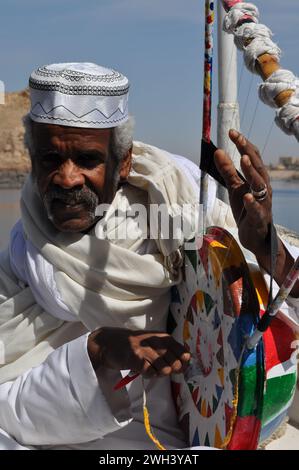 Oriental Nubian Musician On a boat behind aswan dam Stock Photo